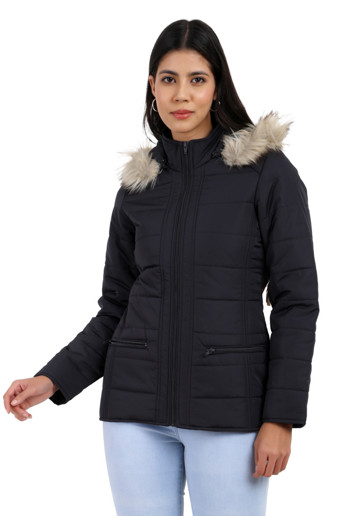 A woman in a standing pose, wearing Trufit’s dark grey Matte Quilted Jacket with Horizontal Pockets, zip closure, a removable hood and blue jeans.